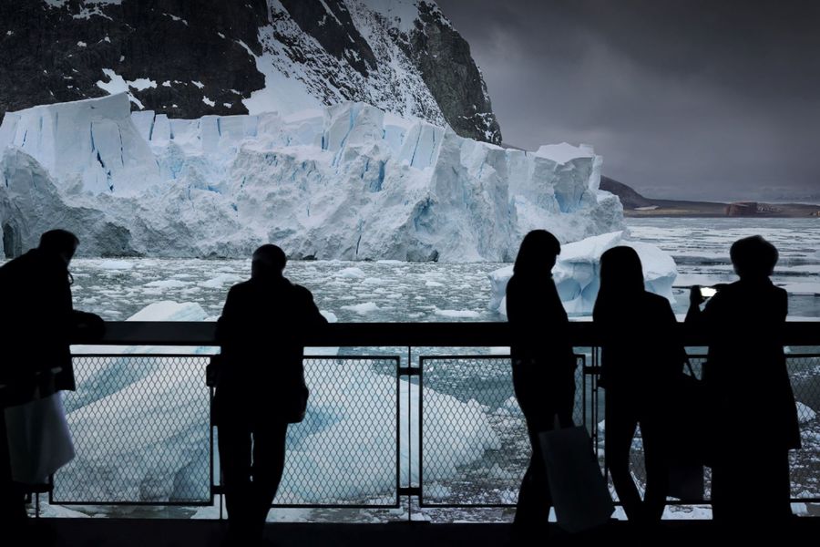 5 Personen stehen auf dem Besucherturm und betrachten das ANTARKTIS Panorama.